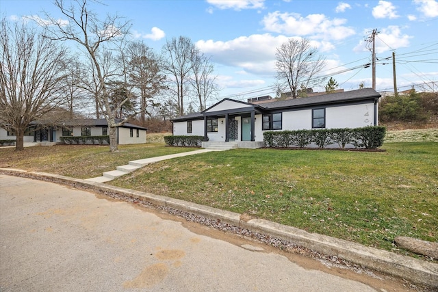 ranch-style home featuring a front lawn