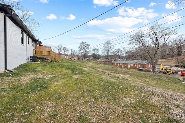 view of yard featuring cooling unit and a wooden deck