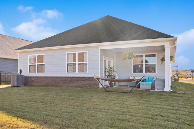 rear view of property with central AC, a yard, and an outdoor hangout area