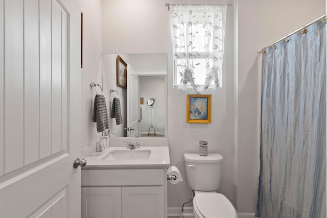 bathroom featuring vanity and toilet