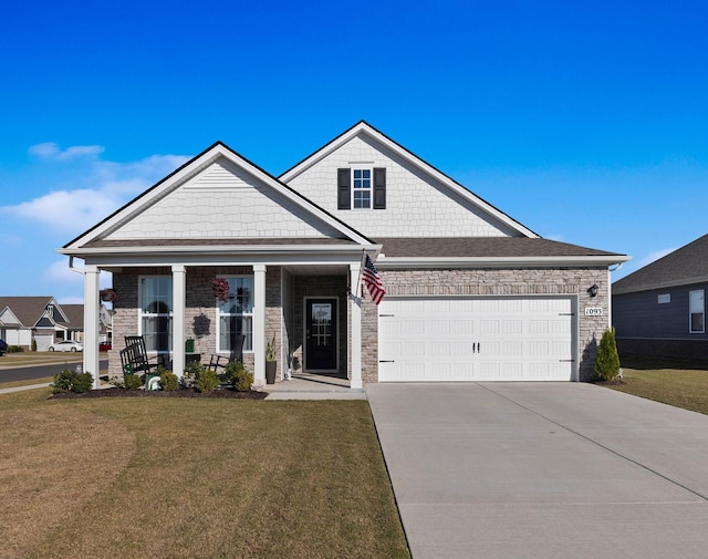 view of front facade featuring a garage, a front yard, and a porch