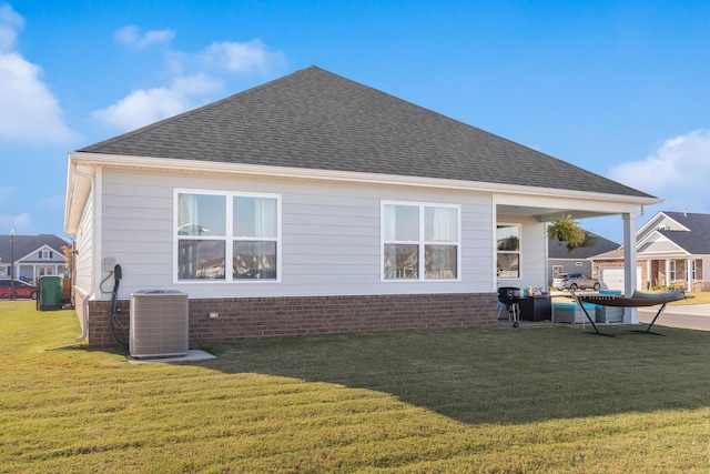 back of house featuring a yard and central AC unit