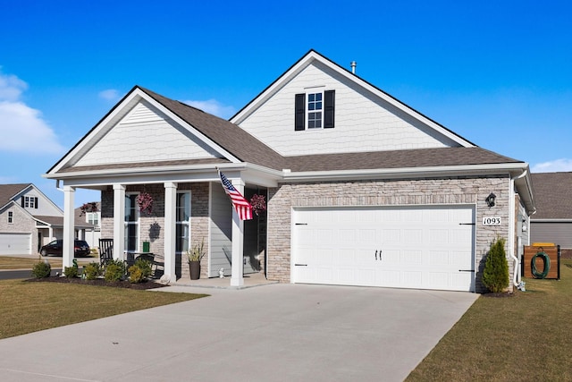 view of front of property with a garage, a front yard, and covered porch