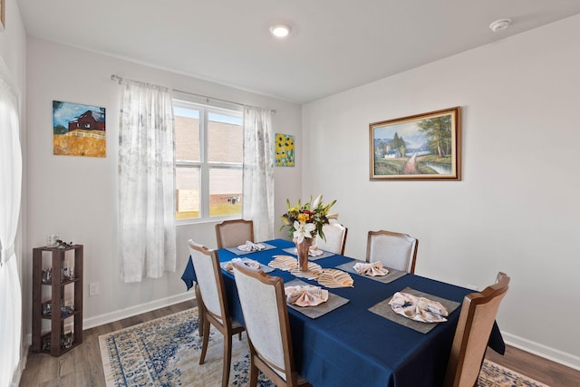 dining space featuring wood-type flooring