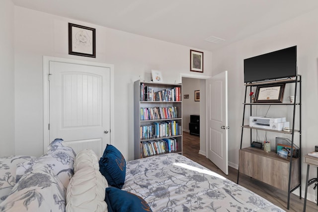 bedroom featuring dark hardwood / wood-style flooring