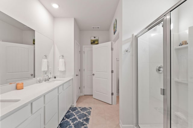 bathroom featuring vanity, tile patterned floors, and walk in shower