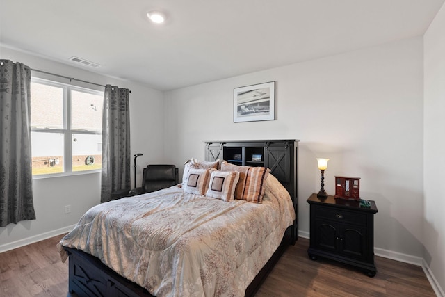 bedroom with dark wood-type flooring