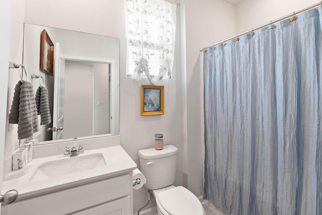 bathroom featuring vanity, a shower with curtain, and toilet