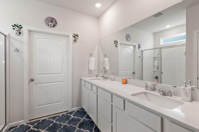 bathroom with an enclosed shower and vanity