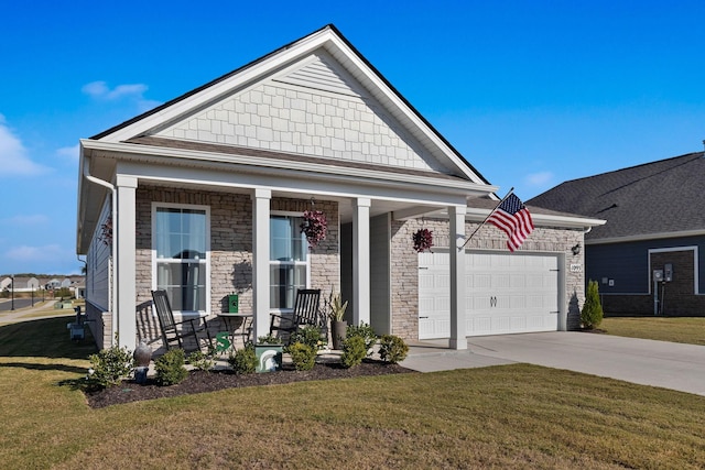 view of front facade featuring a garage, covered porch, and a front lawn