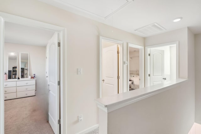 hallway featuring light colored carpet