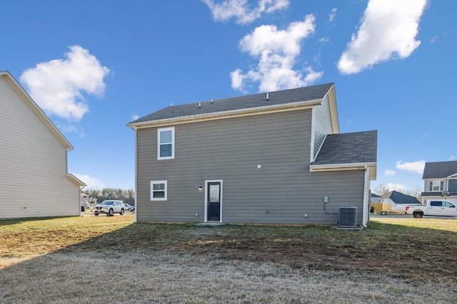 rear view of property with central AC