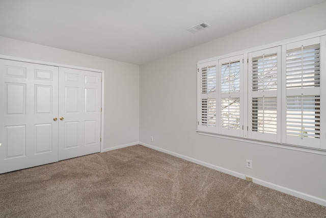 unfurnished bedroom with a closet and carpet