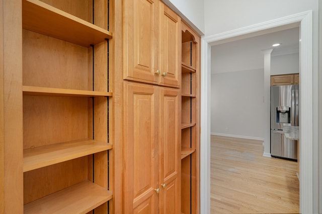 interior space with hardwood / wood-style floors and stainless steel fridge