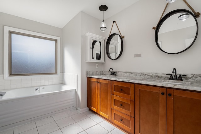 bathroom with tile patterned flooring, vanity, and a bathing tub