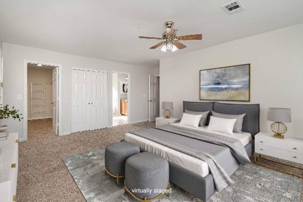 bedroom featuring ensuite bathroom, ceiling fan, and carpet flooring