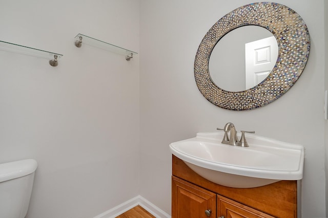 bathroom with vanity, hardwood / wood-style floors, and toilet