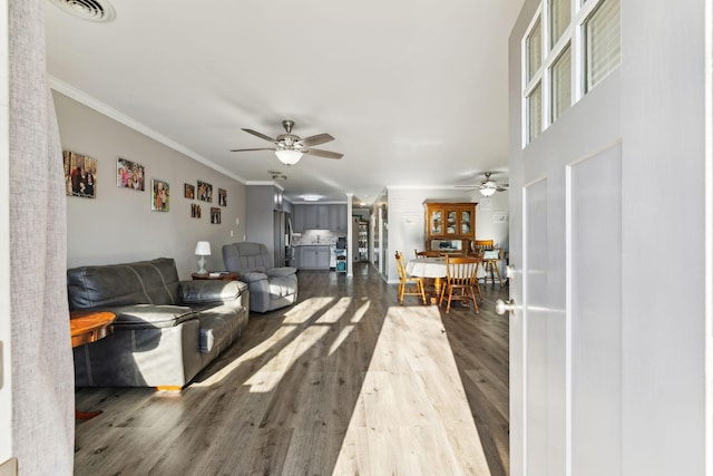 living room featuring ceiling fan, ornamental molding, and hardwood / wood-style floors