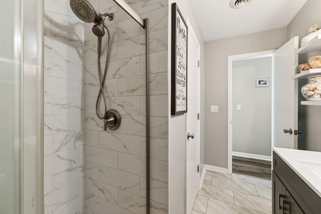 bathroom featuring vanity and a tile shower