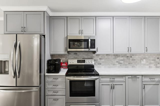 kitchen featuring tasteful backsplash, stainless steel appliances, and gray cabinets