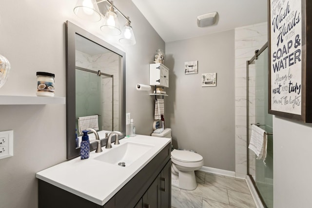 bathroom featuring vanity, toilet, and a shower with shower door