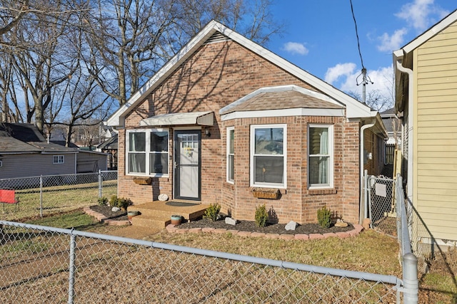 bungalow-style house featuring a front yard