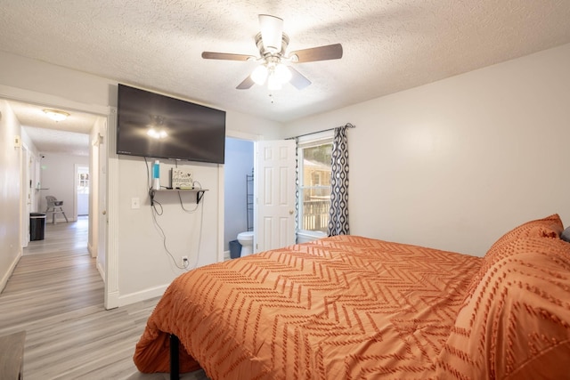 bedroom with ceiling fan, access to outside, light hardwood / wood-style floors, and a textured ceiling