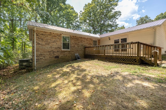 back of property with a wooden deck and central air condition unit