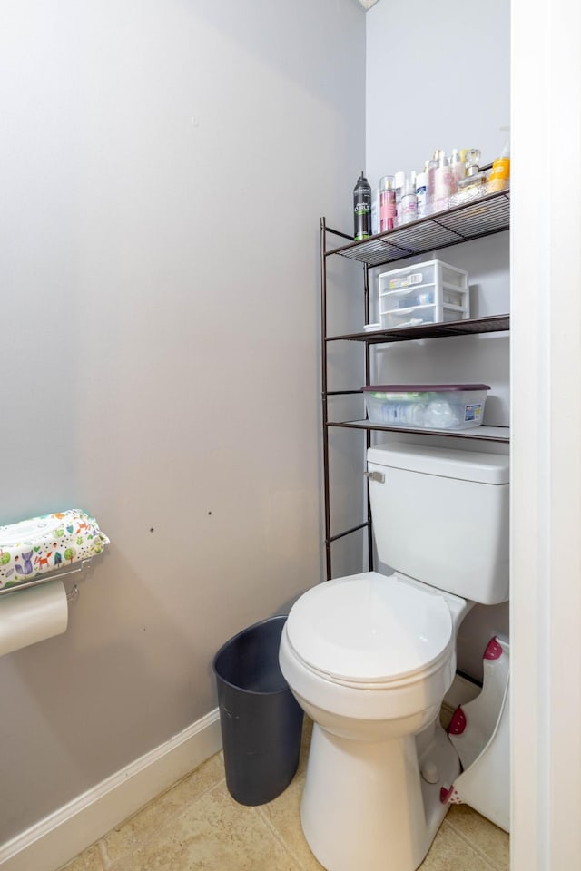 bathroom featuring toilet and tile patterned flooring