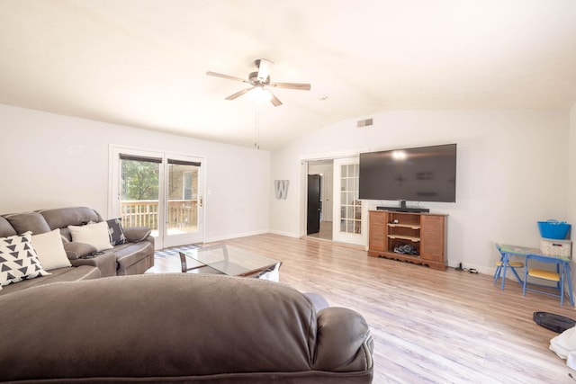 living room with ceiling fan, lofted ceiling, light hardwood / wood-style floors, and french doors