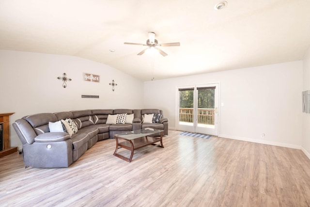 living room featuring ceiling fan, vaulted ceiling, and light hardwood / wood-style flooring