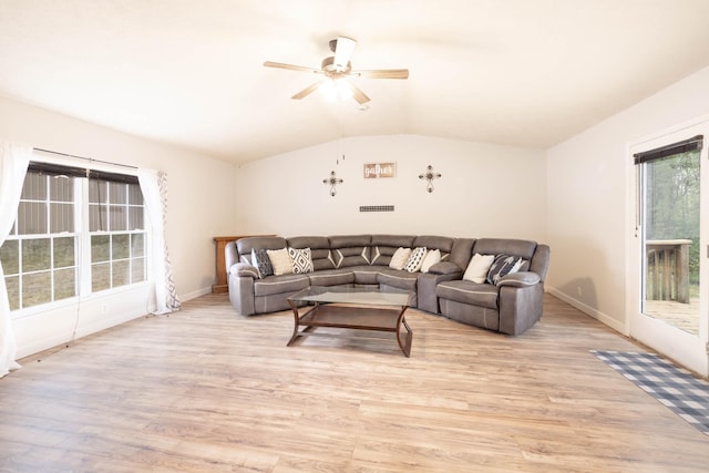 living room with vaulted ceiling, ceiling fan, and light wood-type flooring