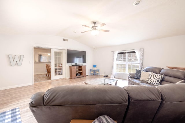 living room with french doors, ceiling fan, lofted ceiling, and light wood-type flooring