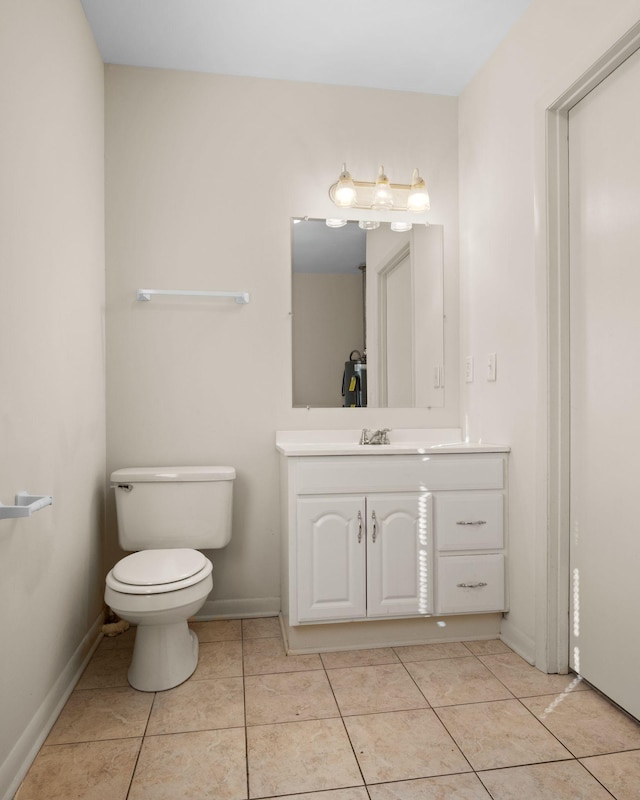 bathroom with vanity, tile patterned floors, and toilet