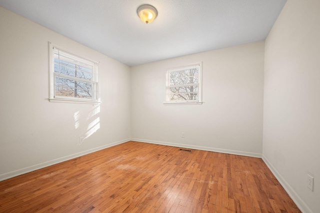 unfurnished room featuring hardwood / wood-style floors