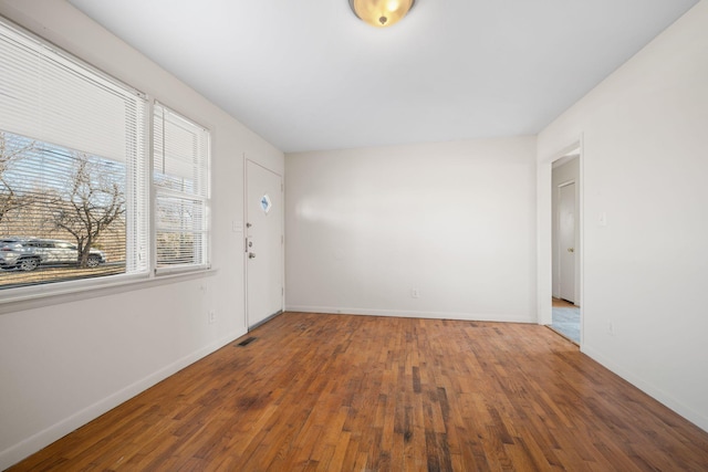 unfurnished room with hardwood / wood-style flooring