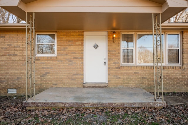 view of exterior entry featuring a patio area