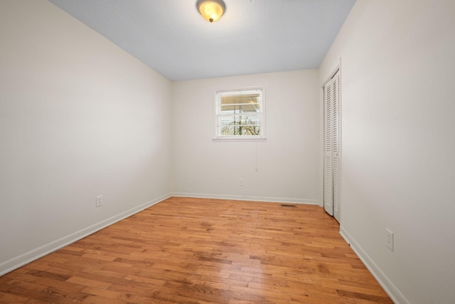 unfurnished room with light hardwood / wood-style flooring