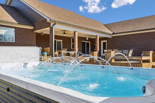 view of pool featuring pool water feature and ceiling fan