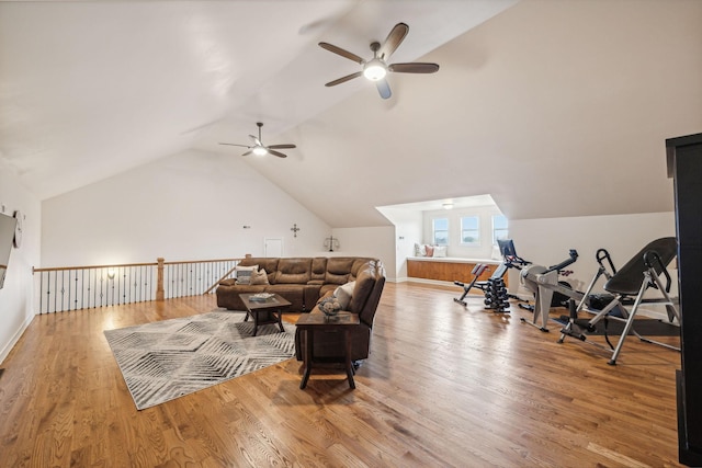 living room with vaulted ceiling and light wood-type flooring