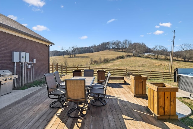 wooden terrace with area for grilling and a rural view