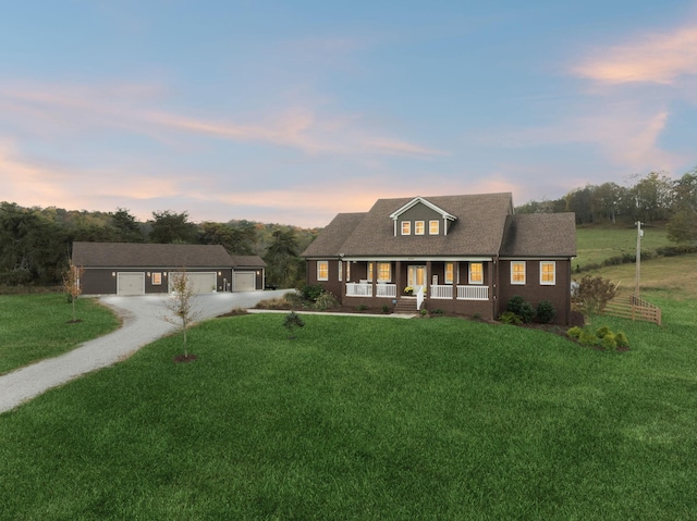 new england style home with a porch and a lawn