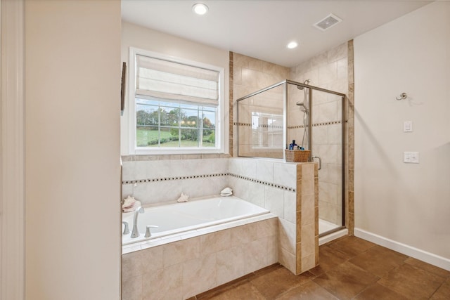 bathroom with independent shower and bath and tile patterned flooring