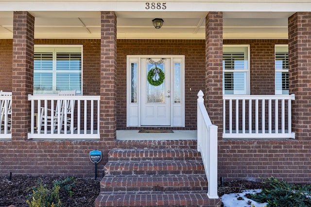 view of exterior entry featuring a porch