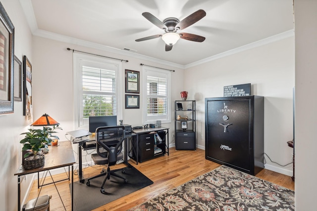 home office featuring ceiling fan, ornamental molding, and light wood-type flooring