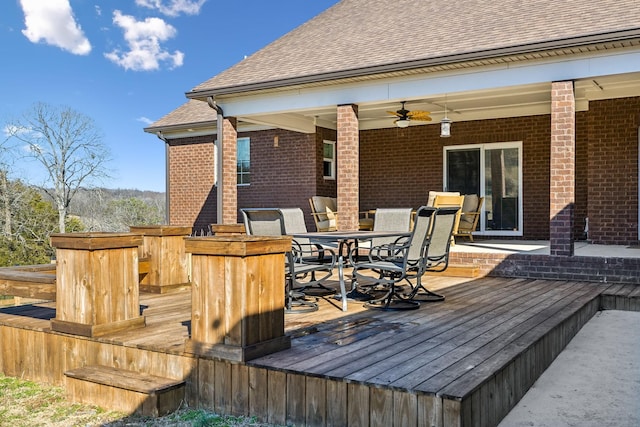 wooden terrace featuring ceiling fan and exterior bar