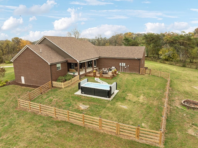 back of house featuring an outdoor living space and a lawn