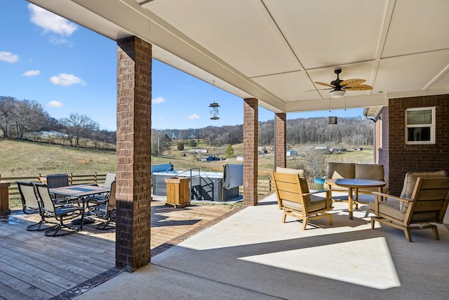 view of patio with a wooden deck, an outdoor hangout area, and ceiling fan