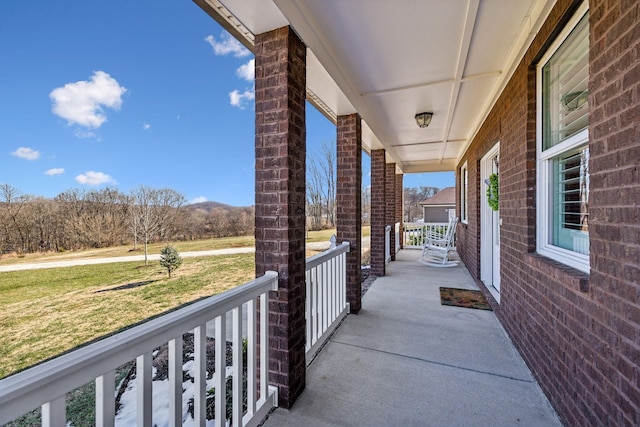 view of patio / terrace featuring a mountain view and covered porch