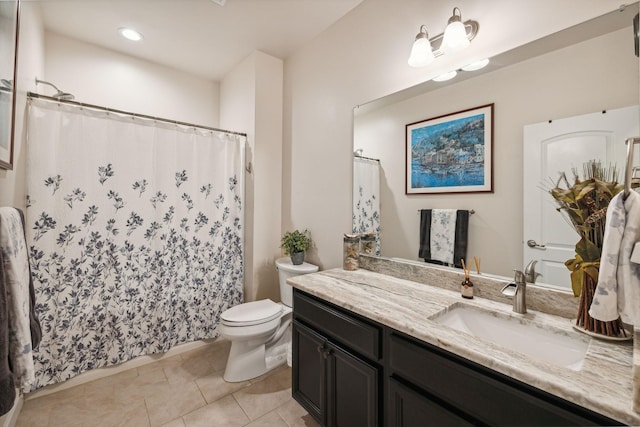 bathroom featuring vanity, tile patterned floors, and toilet